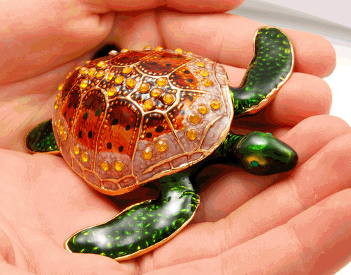Orange Turtle Cremation Keepsake shown in hands